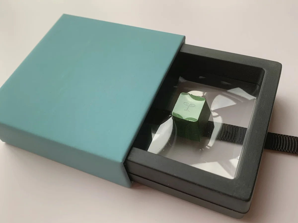 Green Artisan Keycap: Vibrant Spring Bud Green Aluminum keycap, intricate design, premium metallic finish from an angled view, highlighting Cherry R4 profile.