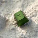 Vibrant Spring Bud Green aluminum artisan keycap, detailed from a side angle, revealing its intricate bud design and premium Cherry R4 profile.
