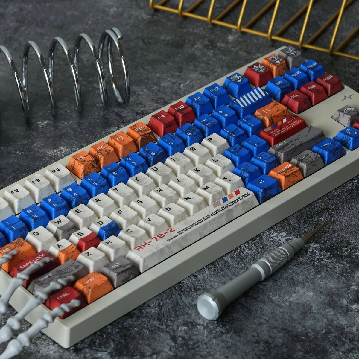 Artistic display of RX-78-2 Battle-Damaged Gundam keycaps set, highlighting the iconic mecha aesthetic and intricate, battle-worn detailing.