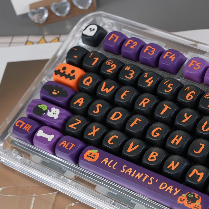 Vibrant Halloween PBT dye-sub keycaps set for mechanical keyboards. Playful pumpkins, ghosts, and bats on dark. High-quality set, shown from a fresh angle.