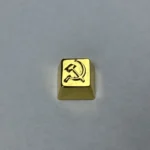 Premium gold-plated brass Hammer Sickle Keycap, highlighting its iconic design and exquisite metallic luster. A handcrafted artisan piece.