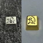 Premium Hammer Sickle Keycap, a pure copper artisan piece with iconic design, featuring lustrous brass and white copper plating, embodying industrial design.