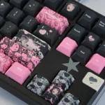 Explore the unique Hello Kitty PBT dye-sub keycap set in its sweet and edgy black and pink style, viewed from various playful angles.