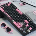 Product gallery views of the unique Hello Kitty PBT Dye-Sub Keycap Set, showing its iconic sweet and edgy black and pink style from multiple angles.