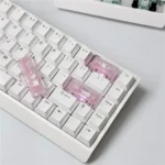 A collection of handmade Hello Kitty cherry profile accent keycaps in vibrant pink and white, displayed from various angles to highlight their charming design.
