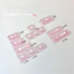 Close-up of a handcrafted Hello Kitty accent keycap, showcasing its vibrant pink and white design and iconic character details from a unique angle.