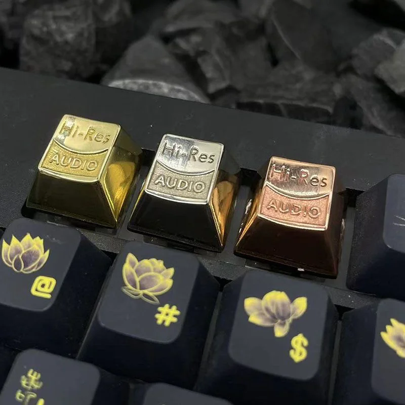 A collection of lustrous Hi-Res Audio pure keycaps, showcasing precise CNC detailing from various angles, emphasizing their premium artisan quality.