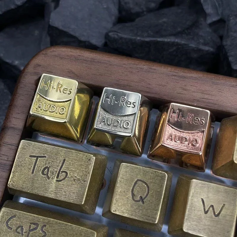 Close-up of a premium pure metallic Hi-Res Audio keycap, showcasing its lustrous finish and precise CNC detailing for a resonant HIFI typing experience.