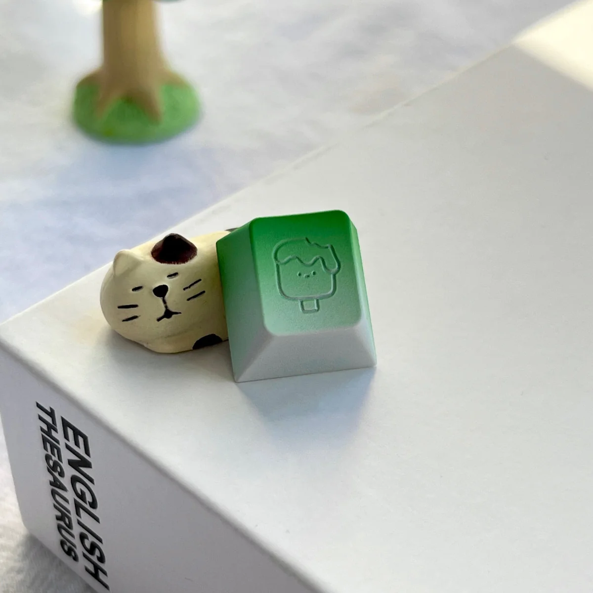 A vibrant, handcrafted aluminum ice cream artisan keycap, viewed from a delightful angle, highlighting its polished metallic shine and playful detail.