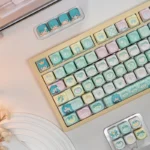 Vibrant Hatsune Miku PBT dye-sublimated keycaps set, showcasing playful character art and pop culture aesthetics for a unique Vocaloid keyboard set.