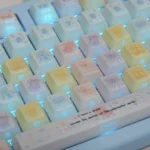 Vibrant, translucent Jellyfish PBT keycap set for mechanical keyboards, showcasing ethereal pink and purple from multiple angles.