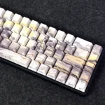 A collection of Jinxian Celestial Elegance side-lit PBT keycaps Set, intricately side-engraved with mythical Chinese legends, glowing brilliantly from various angles.