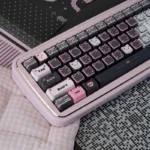 Delightful side view of the Adorable Lace Cat PBT MAO keycap Set, highlighting its vibrant black and pink design and durable dye-sublimated lace details.