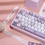 Exclusive Kuromi's Diary PBT Dye-Sub Keycap Set. Whimsical illustrations, playful purple accents. Multiple angles for mischievous fun.