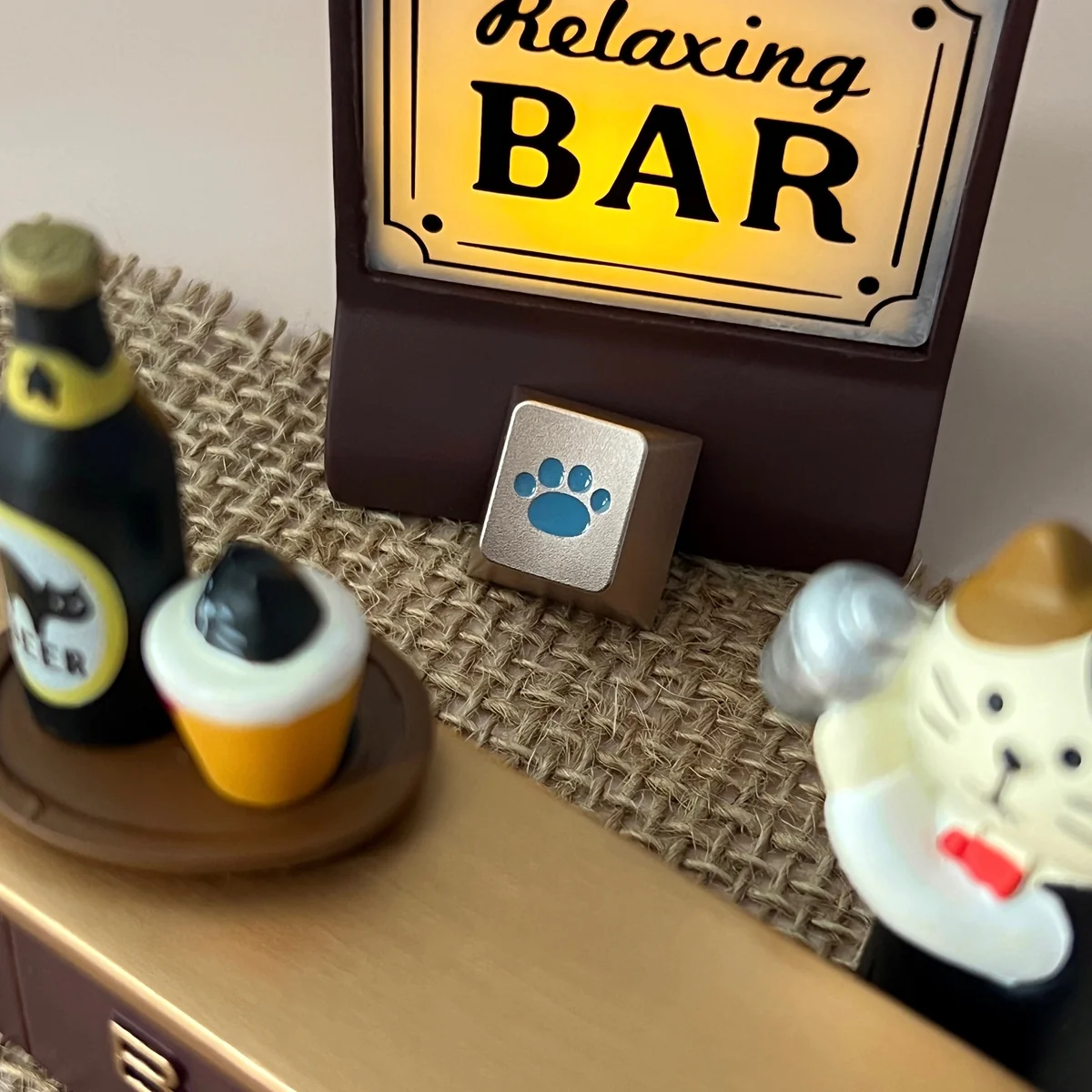 Close-up views of the whimsical lake blue cat paw keycap, showcasing its premium CNC aluminum craftsmanship and charming R4 design from various angle.