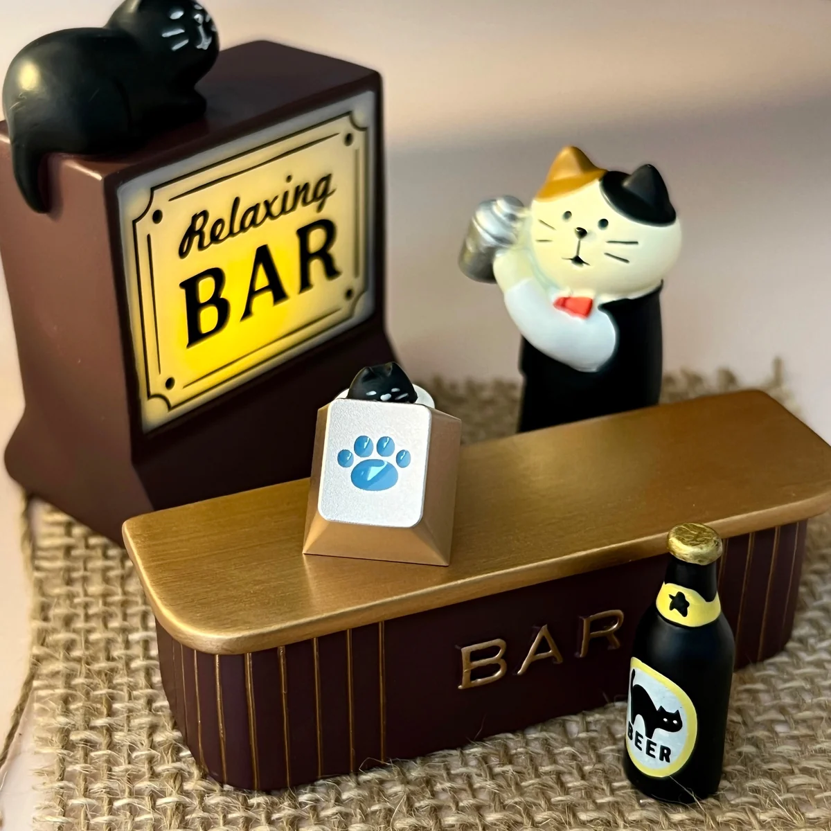 Close-up of a whimsical lake blue cat paw keycap, crafted from premium CNC aluminum, emphasizing its charming detail and playful aesthetic for mechanical keyboard.