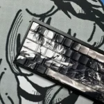 Close-up of premium Levi Ackerman PBT side-lit keycaps set, highlighting their durable build and subtle side-printed legends, ideal for dark tactical backlight.