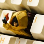 Close-up of a handcrafted Little Nightmares Six ESC keycap, a dark and detailed resin piece embodying the eerie, artistic style of the game.