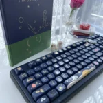 An enchanting Little Prince PBT dye-sub keycap set, showcasing its whimsical pollen-inspired motif and dreamy soft hues from a unique angle.