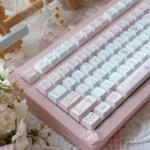 A close-up view of the exclusive Love Alarm PBT Dye-sub Keycaps set, showcasing the soft romantic aesthetic and playful 'Love Alarm' motifs.