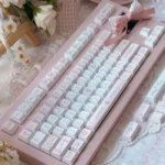 Close-up of the exclusive Love Alarm PBT dye-sub keycaps set, showcasing its soft romantic aesthetic with iconic motifs and a gentle color palette.