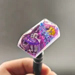 Detailed view of the handcrafted Mewtwo & Mew resin keycap, capturing the dynamic psychic energy and translucent resin artistry. A unique Pokemon collection.