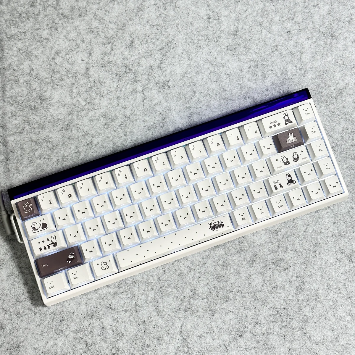 A playful Miffy PBT keycap set showcased from various angles, highlighting the whimsical side-printed translucent legends and durable PBT texture.