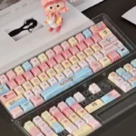 A fresh, vibrant Mirmo! anime PBT dye-sub keycap set featuring whimsical characters and magical motifs. An exclusive, playful new Cherry design.