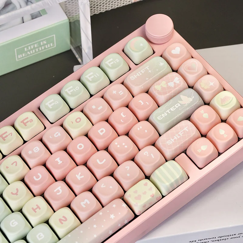 A unique angle of the Whimsical Pink Gradient Melon MOA PBT Keycap Set, highlighting its cute soft pink to white pastel gradient and sweet melon MOA profile.