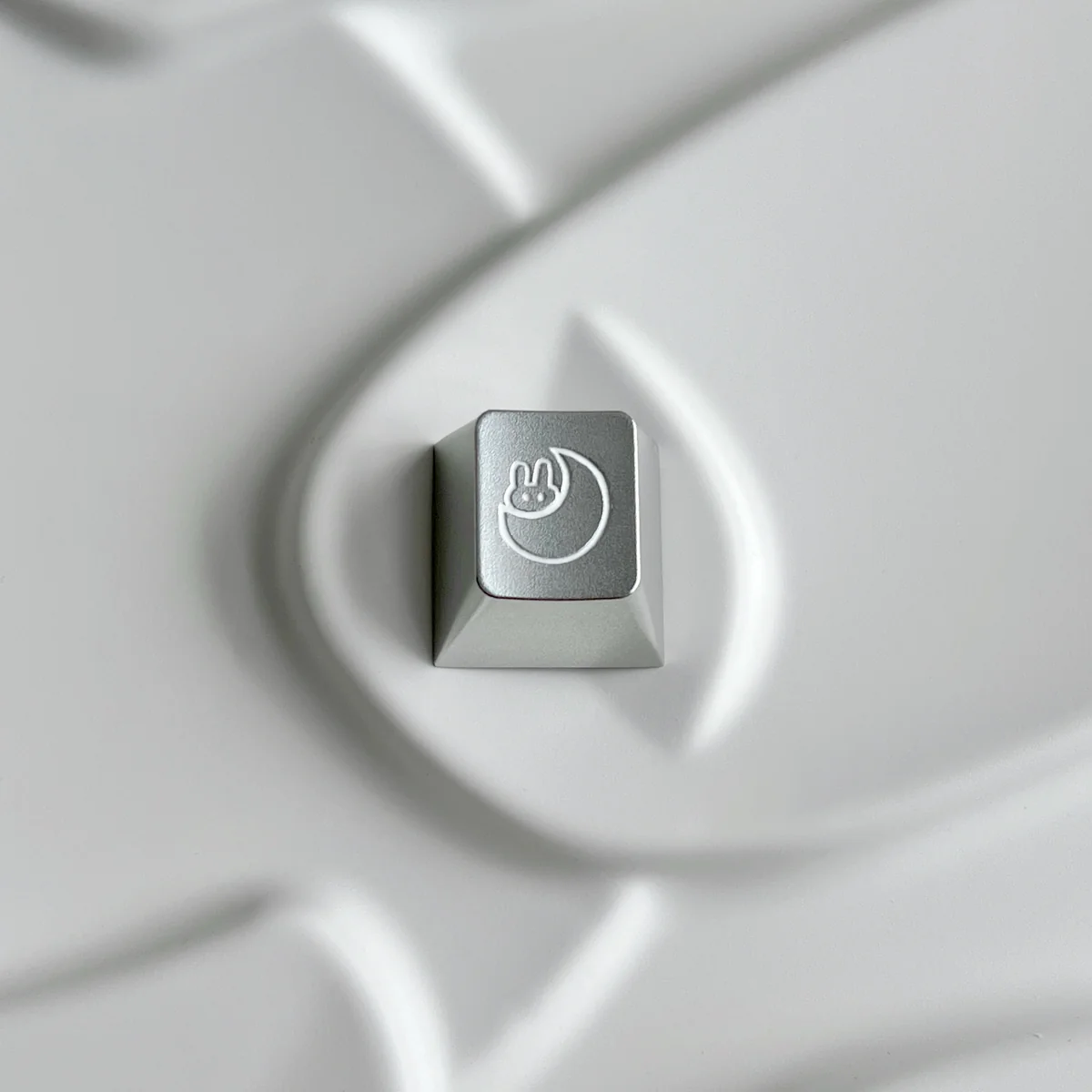 Close-up of the Serene Moon Rabbit Keycap, showcasing its precision CNC aluminum build, intricate lunar rabbit motif, and metallic sheen.