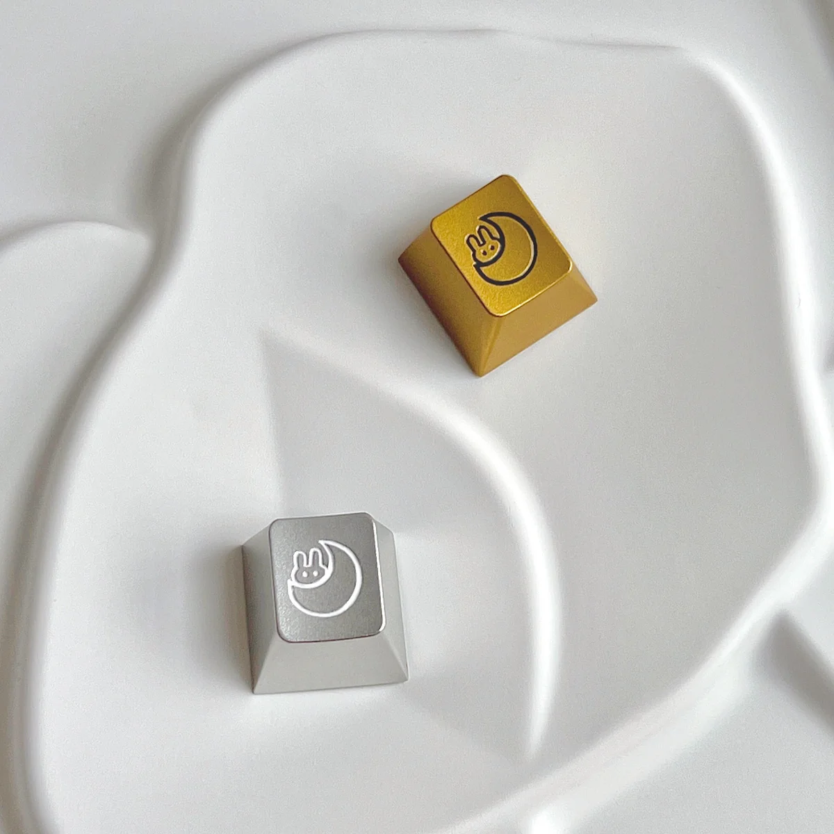 Artistic Serene Moon Rabbit Keycap, precision CNC aluminum, intricate lunar rabbit motif with a sleek metallic sheen, enhancing any keyboard's sophiscated.
