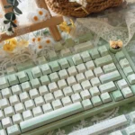 Tranquil Moss Whisper PBT Dye-Sub Keycap Set, shown from various angles. Serene moss-green and earthy tones create a premium, nature-inspired desktop.