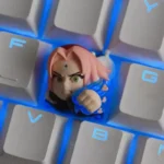 A vibrant Naruto: Gritty Sakura Haruno Keycap, showcasing detailed anime art in translucent resin. Captured from an artistic angle.