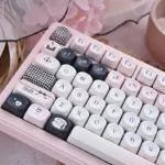 Original Sin Keycap Set: a gallery view of unique black and pink MOA profile keycaps from various artistic angles, blending dark allure with cute design.