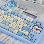 Exclusive Osborn keycaps, 135-key PBT set. Multiple angles reveal romantic character art, celestial elements, and elegant dark/light contrasts.