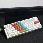 Vibrant, intricately painted PBT keycaps set, seen from a unique angle, highlighting dye-sublimated designs for mechanical keyboards.