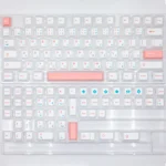 Artistic PBT keycap set in serene ice berry pink and sky blue pastels, showcasing durable dye-sub legends from various angles.