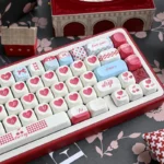 Nostalgic Sweet Cherry PBT keycap set for mechanical keyboards, displayed from various playful angles, emphasizing its durable quality and soft design.