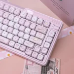 Sweet milk candy pink PBT keycaps set, ergonomic MOA profile, displayed from multiple angles. Highlights soft pastel colors and delightful, rounded, charming setup.