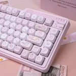 Sweet milk candy pink PBT keycaps set, highlighting their ergonomic MOA profile. Soft pastel colors and a rounded design create a playful aesthetic.