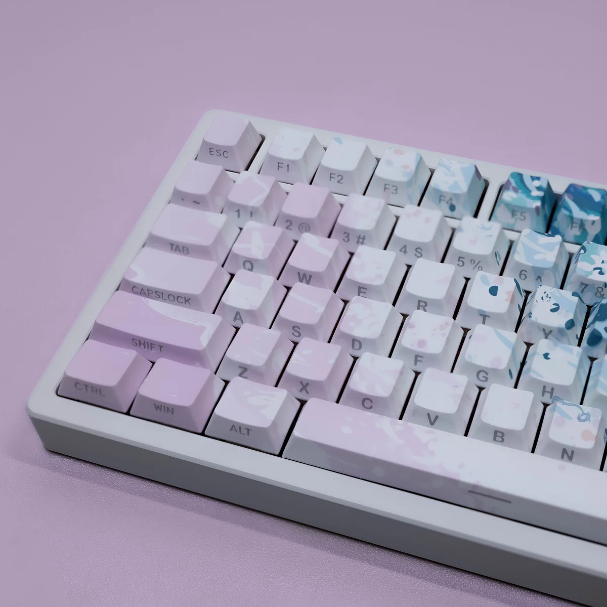 Dreamy Pink Beach PBT keycaps set showcasing a close-up angle of the serene coastal design, featuring soft pinks and warm neutrals. Durable PBT material.