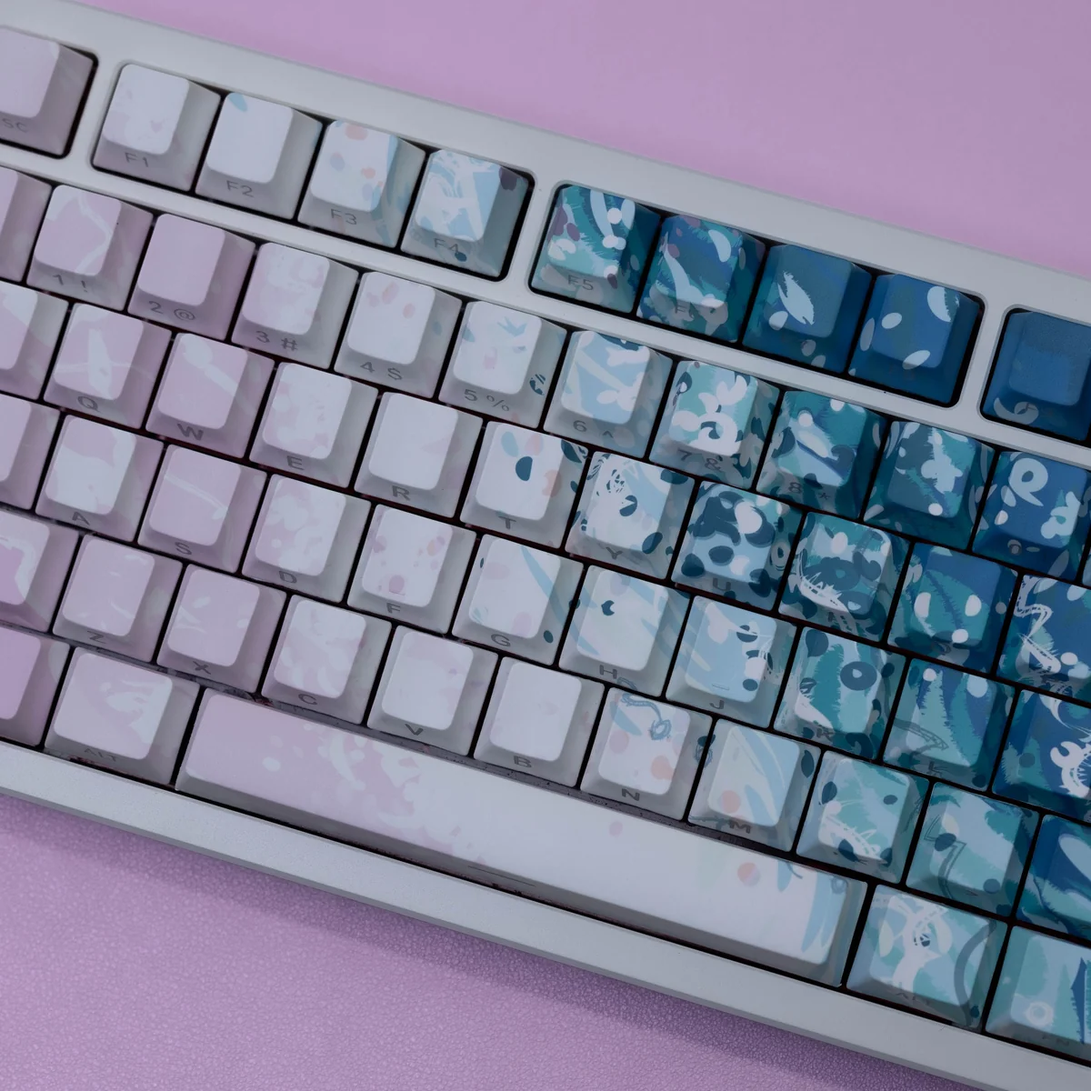 Close-up of Dreamy Pink Beach PBT keycaps set, showcasing their serene coastal aesthetic with soft pinks and warm neutrals, highlighting durable texture.