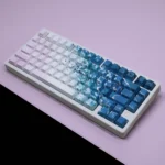 An artistic close-up of Dreamy Pink Beach PBT keycaps set, highlighting their durable texture and soft pink, warm neutral palette from a unique angle.