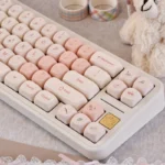 Delicate Pink Cherry MOA PBT keycaps set with enchanting cherry blossom motifs, presented from various angles to reveal their charming spherical retro design.