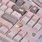Gentle World Pink PBT Keycap Set, Cherry profile. Artistic angles highlight durable PBT, serene pastel design, and broad compatibility for a calming aesthetics.