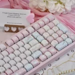 Close-up of a vibrant pink Rock Cat MOA keycap set, showcasing the playful cartoon characters and unique MOA profile from a new angle.