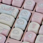 A detailed shot of the unique Pink Rock Cat MOA Keycap Set, showcasing the vibrant pink keycaps and playful cartoon rock cat designs.