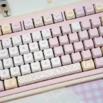 A collection of adorable pink pixel cat PBT keycaps set, showcasing various angles and the playful retro design for a charming keyboard aesthetic.
