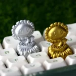 Detailed view of the PvZ Sunflower Trophy Artisan Keycap for ESC, showcasing its iconic Plants vs. Zombies character and vibrant gold finish, a unique design.