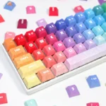 Vibrant rainbow PBT keycaps set, ergonomically designed and dye-sublimated for durability, shown from various angles.